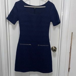 Figure fitting navy blue dress. Faux zipper pockets.